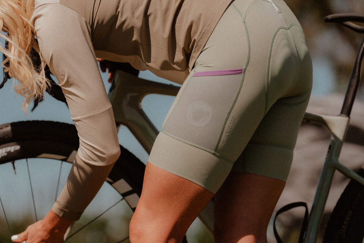 Rider in the Olive Leaf Enduro Bib, leg pocket and gripper cuff